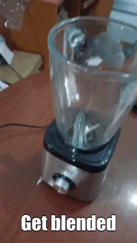 an empty blender on a table with the words get blended below it