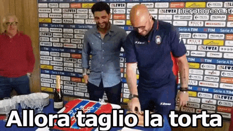 a man is cutting a cake in front of a wall that says serie a tim on it