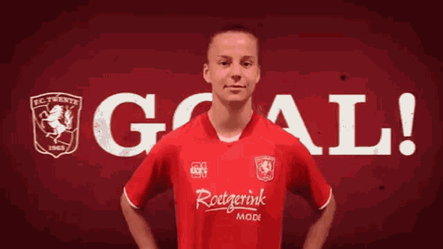 a man wearing a red shirt with the word goal on it