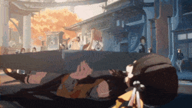 a cartoon character is laying on the ground in front of a building in a video game .
