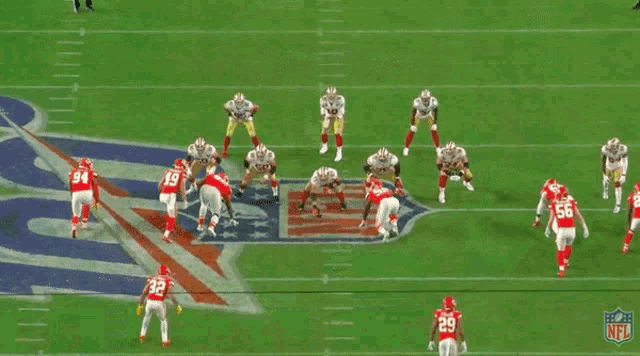 a football game is being played on a field with the nfl logo on the sidelines .