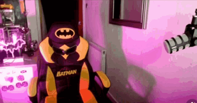 a yellow and purple batman chair with a bat on it