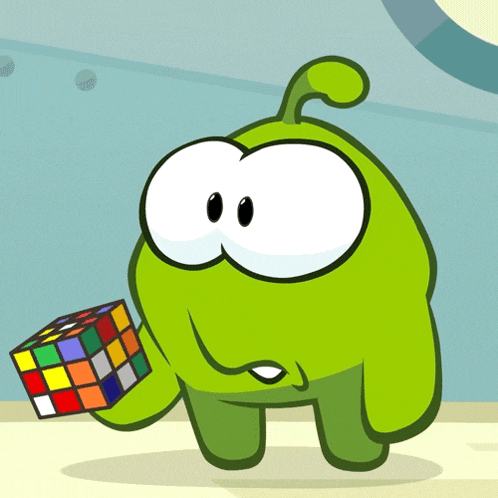 a green cartoon character holding a rubik 's cube
