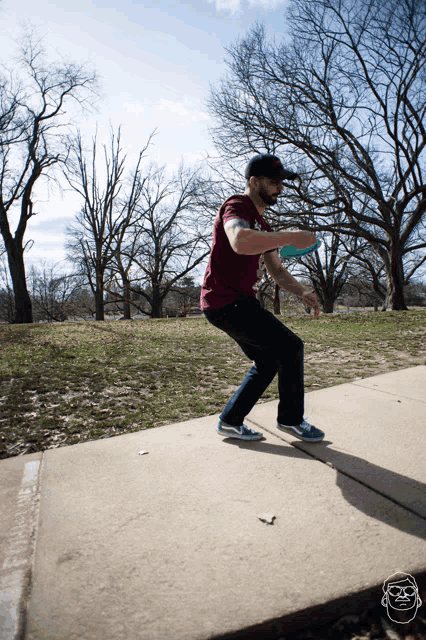 a man throwing a frisbee on a sidewalk wearing a t-shirt that says ' texas ' on it