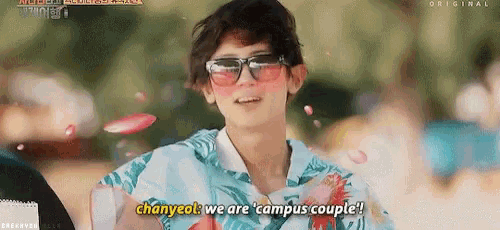 a young man wearing sunglasses and a blue shirt says chanyeol we are campus couple