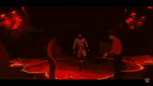 a wrestler is being projected onto a large screen in a dark room