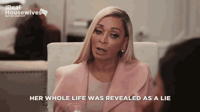 a woman sitting at a table with the words " her whole life was revealed as a lie "