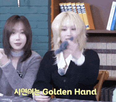 two women are sitting at a table with the words golden hand written on the bottom