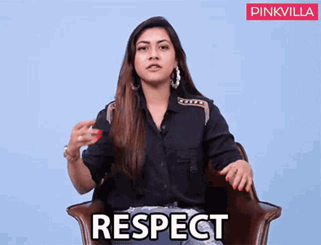 a woman in a black shirt is sitting in a chair with the word respect above her
