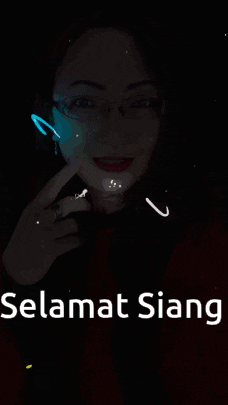 a woman wearing glasses and a red sweater says selamat siang on the bottom