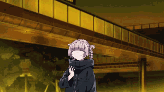 a girl in a black jacket stands under a bridge