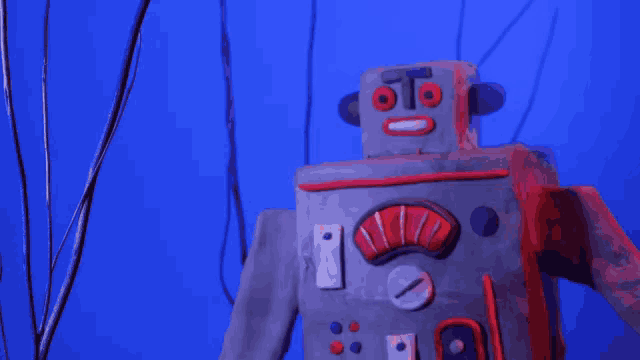 a robot made out of clay has a face that says " oto " on it