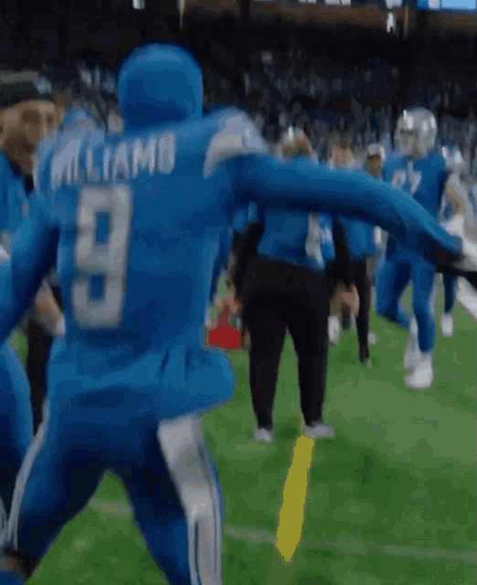 a football player with the number 9 on his back is running on the field