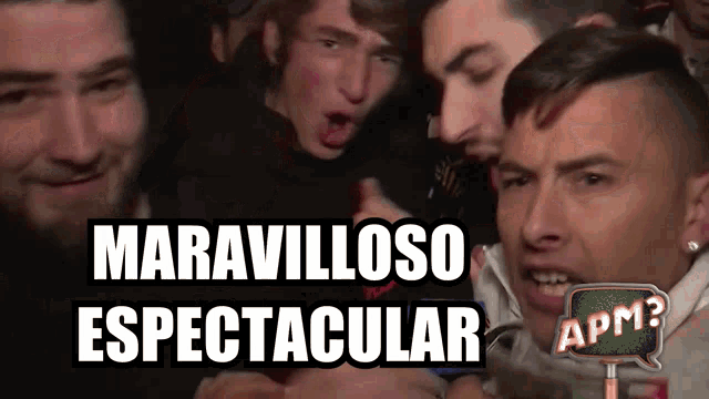 a group of men are standing in front of a sign that says ' espectacular '