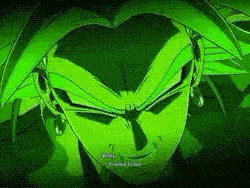 a close up of a green dragon ball z character 's face with a dark background .