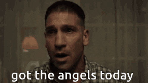 a man in a plaid shirt is crying with the words got the angels today written below him .