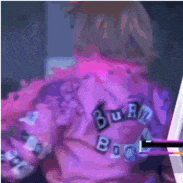 a person wearing a purple shirt that says " bua "