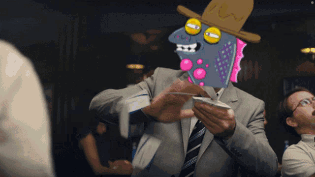 a man in a suit has a cartoon character on his face