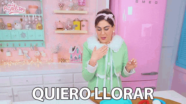 a woman in a kitchen with the words quiero llorar written on the counter