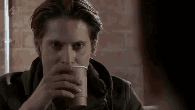 a man drinking a cup of coffee with the channel 4 logo visible