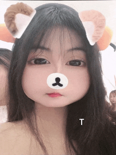 a girl with a teddy bear face on her face and the letter t next to her
