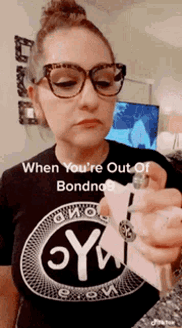 a woman wearing glasses and a t-shirt that says " when you 're out of bondno "