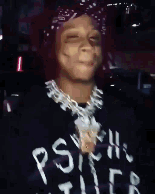 a man wearing a bandana and a sweater that says " rsyh " on it
