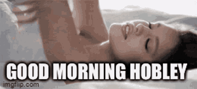 a woman is laying on a bed with the words good morning hobley above her