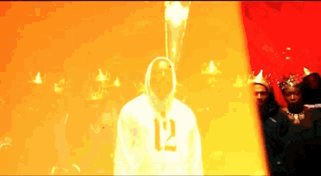a man in a hoodie with the number 12 on the front