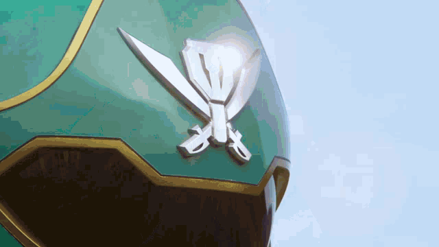 a green helmet with a crossed swords on it