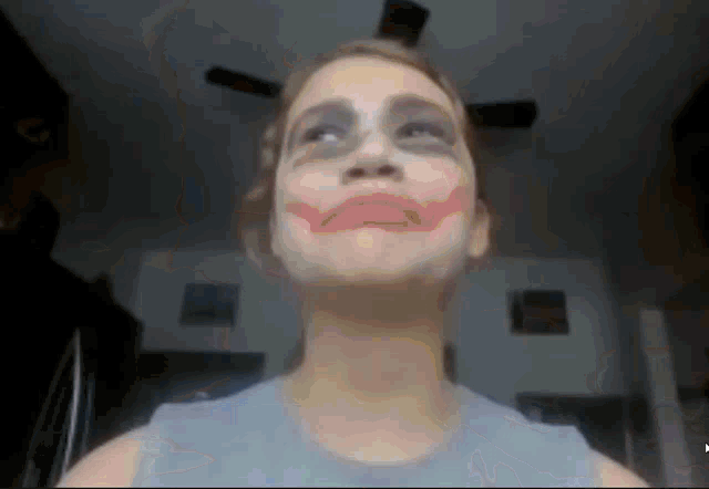 a woman with makeup on her face looks up at the camera