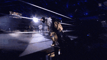 a wrestling ring with a sign that says ' smackdown ' on it in the background