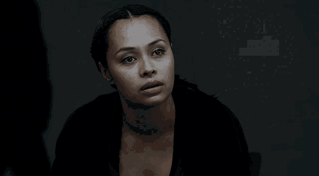 a close up of a woman 's face in the dark