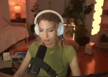 a woman wearing headphones is sitting in front of a microphone in a room .