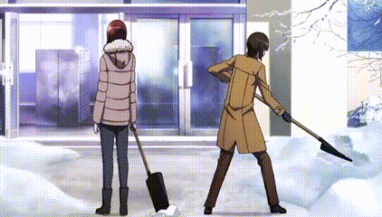 a man is shoveling snow while a woman stands next to him .