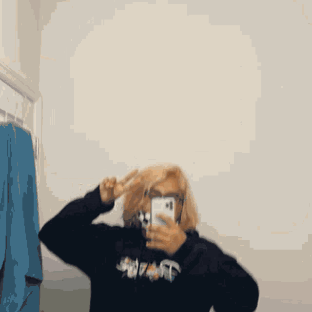 a person taking a picture of themselves in a mirror with their phone