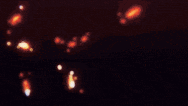 a blurry picture of a lightning bolt in the dark .