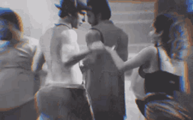 a group of people are standing next to each other .