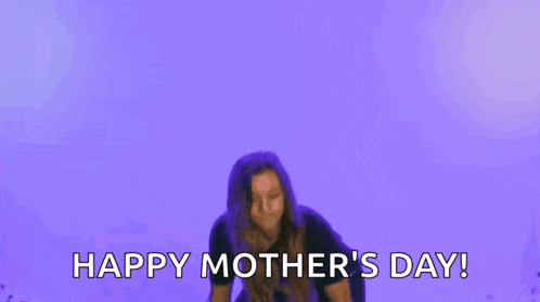 a woman is dancing in front of a purple background and saying `` happy mother 's day '' .