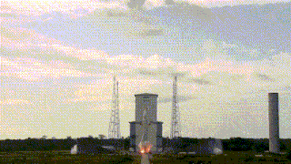 a rocket is being launched from a tower in a field
