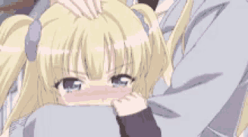 a girl with blonde hair and blue eyes is being comforted by a man