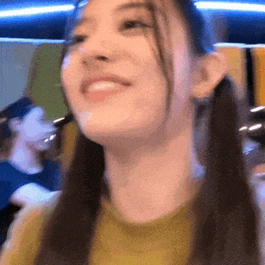 a close up of a woman 's face with ponytails