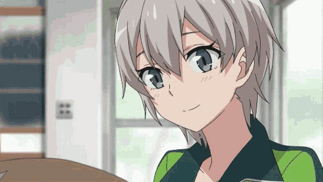 a girl with short hair is wearing a green and white shirt