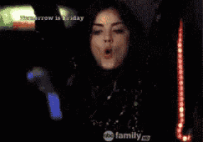 a woman is dancing in front of a sign that says tomorrow is friday on it