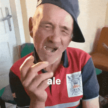 a man wearing a hat and a red and blue shirt with the word ale on it