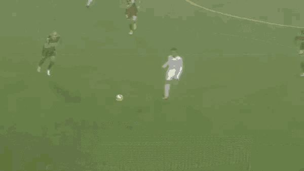 a soccer goalie catches a soccer ball in the net