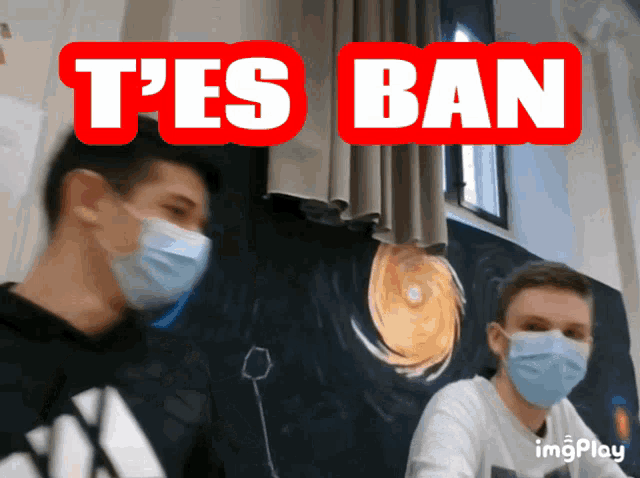 two men wearing face masks are standing in front of a sign that says " t'es ban "