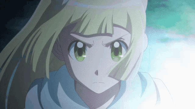 a close up of a girl 's face with green eyes