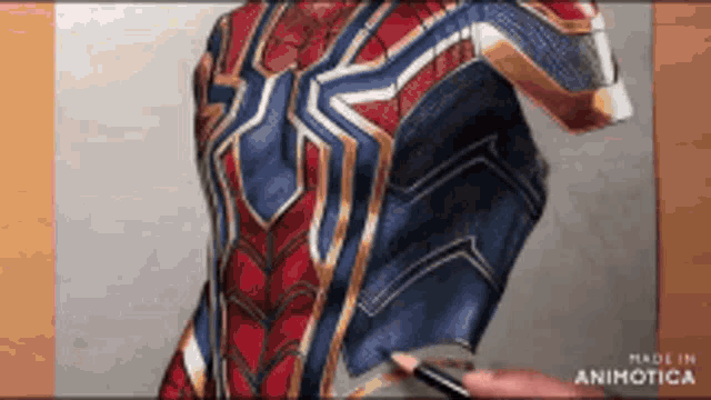 a person is drawing a spiderman suit with a pencil ..