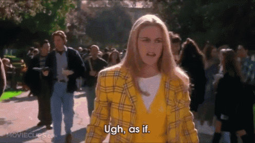 a woman in a yellow plaid jacket is standing in front of a crowd and saying ugh , as if .